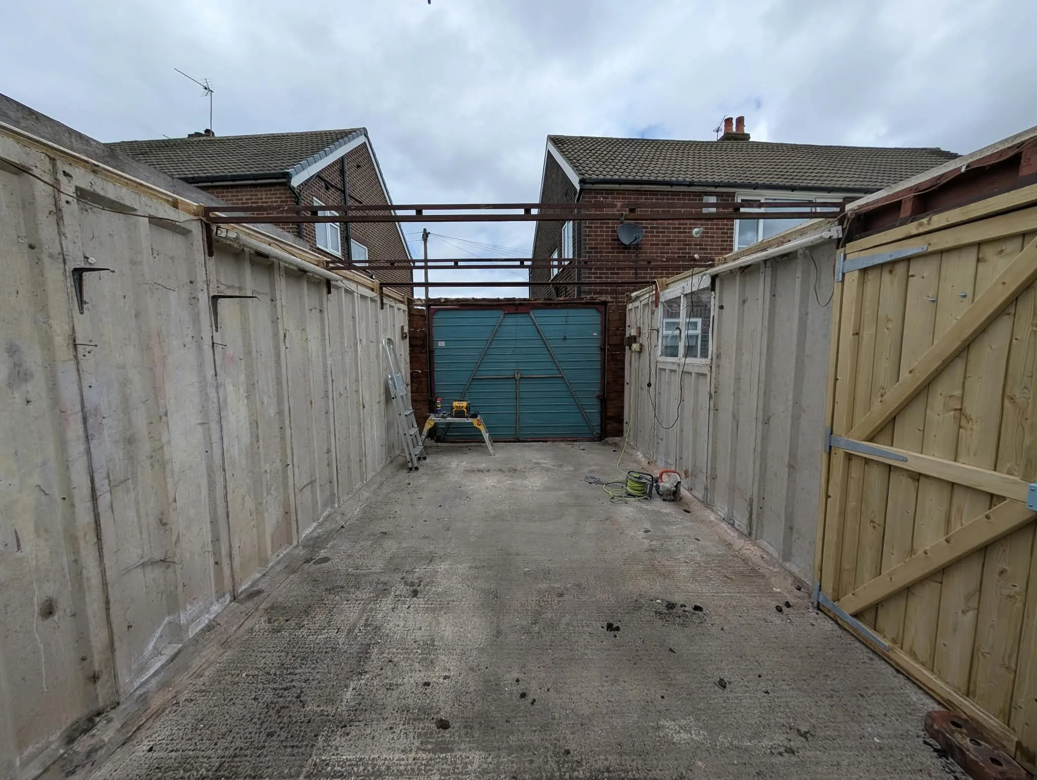 Garage with the roof covering removed and roof members exposed.
