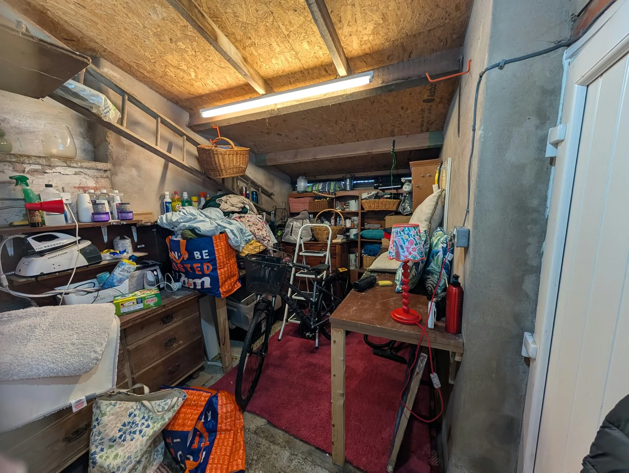 Garage in use for household storage before renovation work.