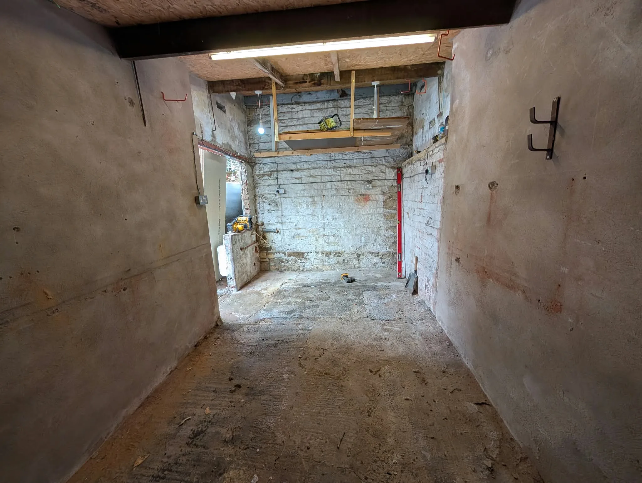 Stripped garage interior with exposed walls and a side opening.