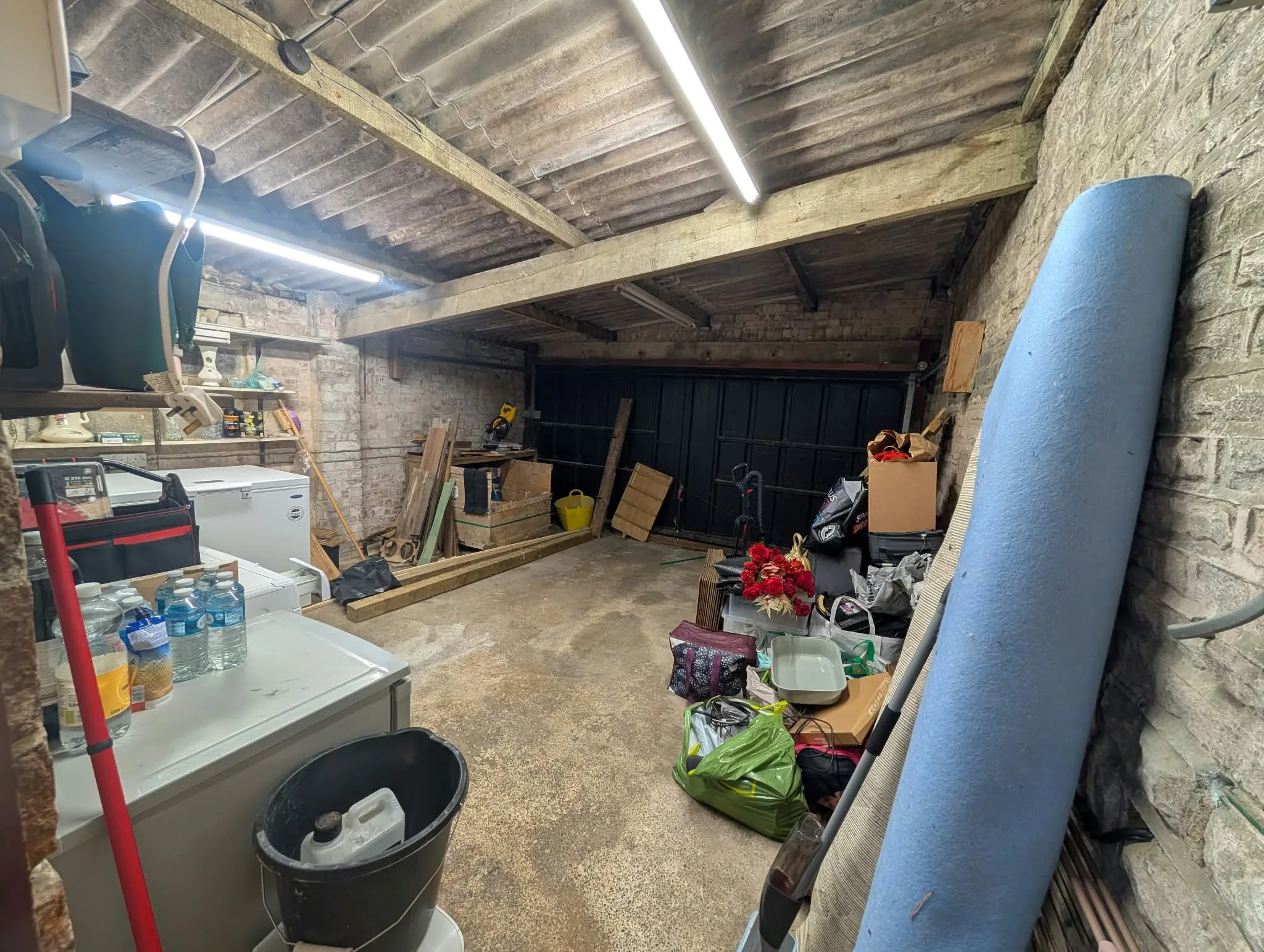 Existing garage used as a workshop and storage area.