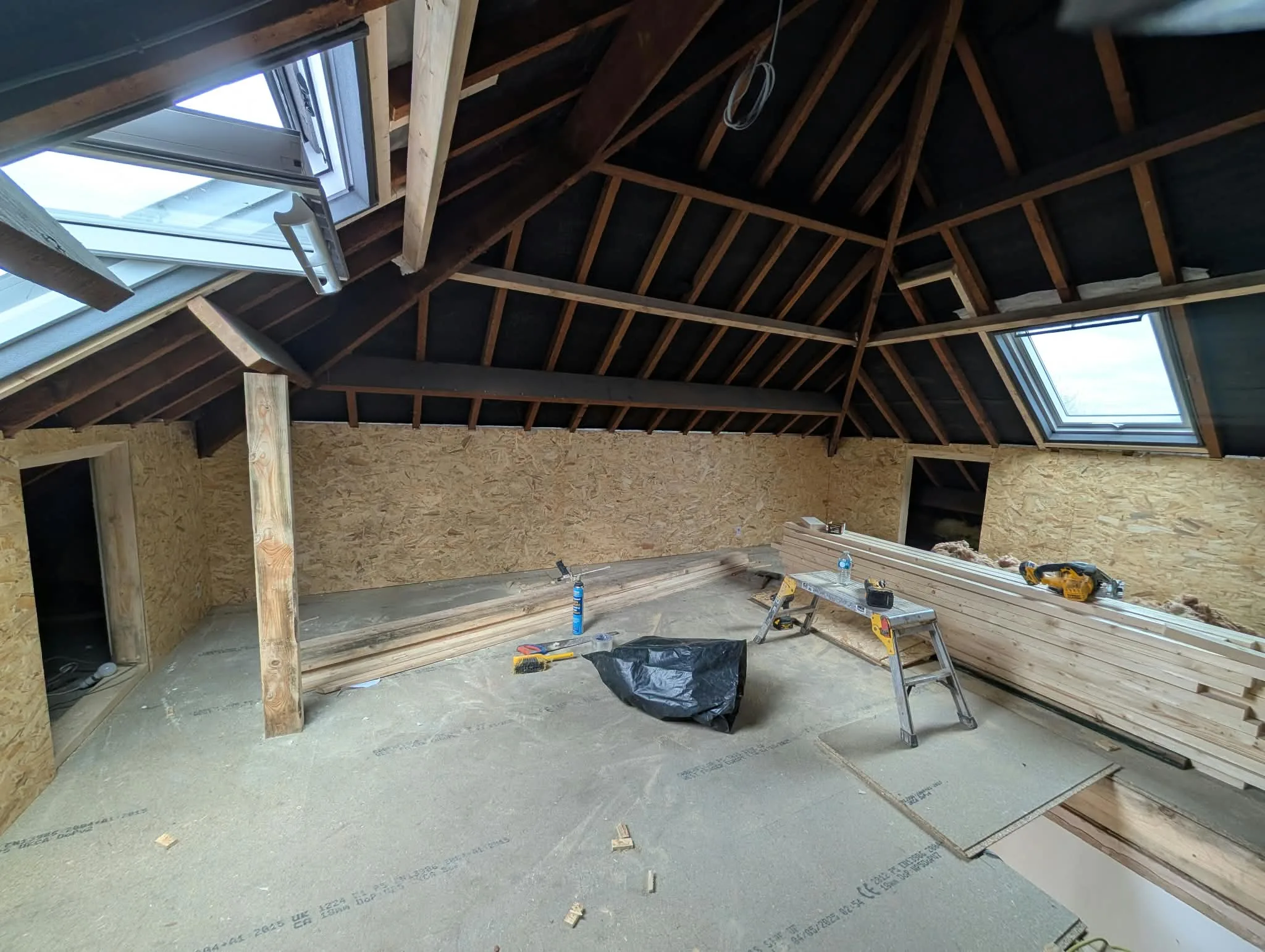 Loft timber framing and rooflights during construction.